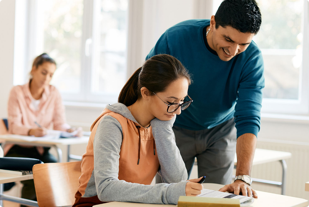 Male teacher helping a student