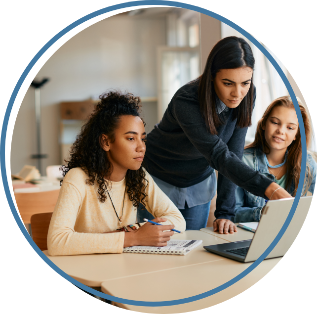 Fenale teacher with students at a computer